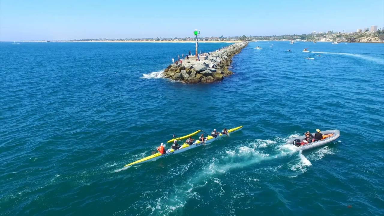 canoes paddling by jetty in ocean